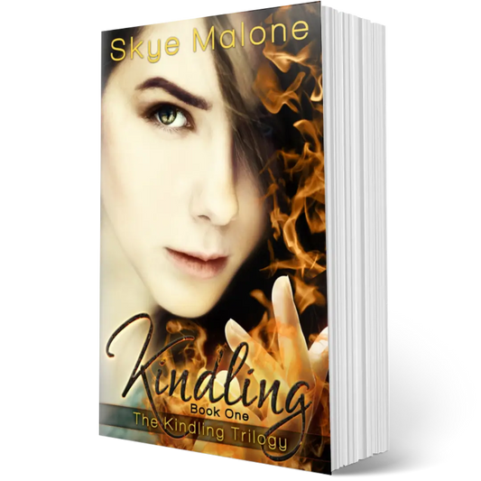 The paperback edition of Kindling by Skye Malone, book one of the Kindling trilogy. A girl with a serious expression and dark hair holds up one hand with fire coming from her fingers.