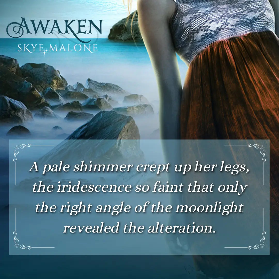 A teaser graphic for Awaken by Skye Malone, book one of the complete young adult mermaid romance Awakened Fate series. A girl in a white and red sundress stands in a dark ocean with rocks behind her. The text on the graphic reads: A pale shimmer crept up her legs, the iridescence so faint that only the right angle of the moonlight revealed the alteration.