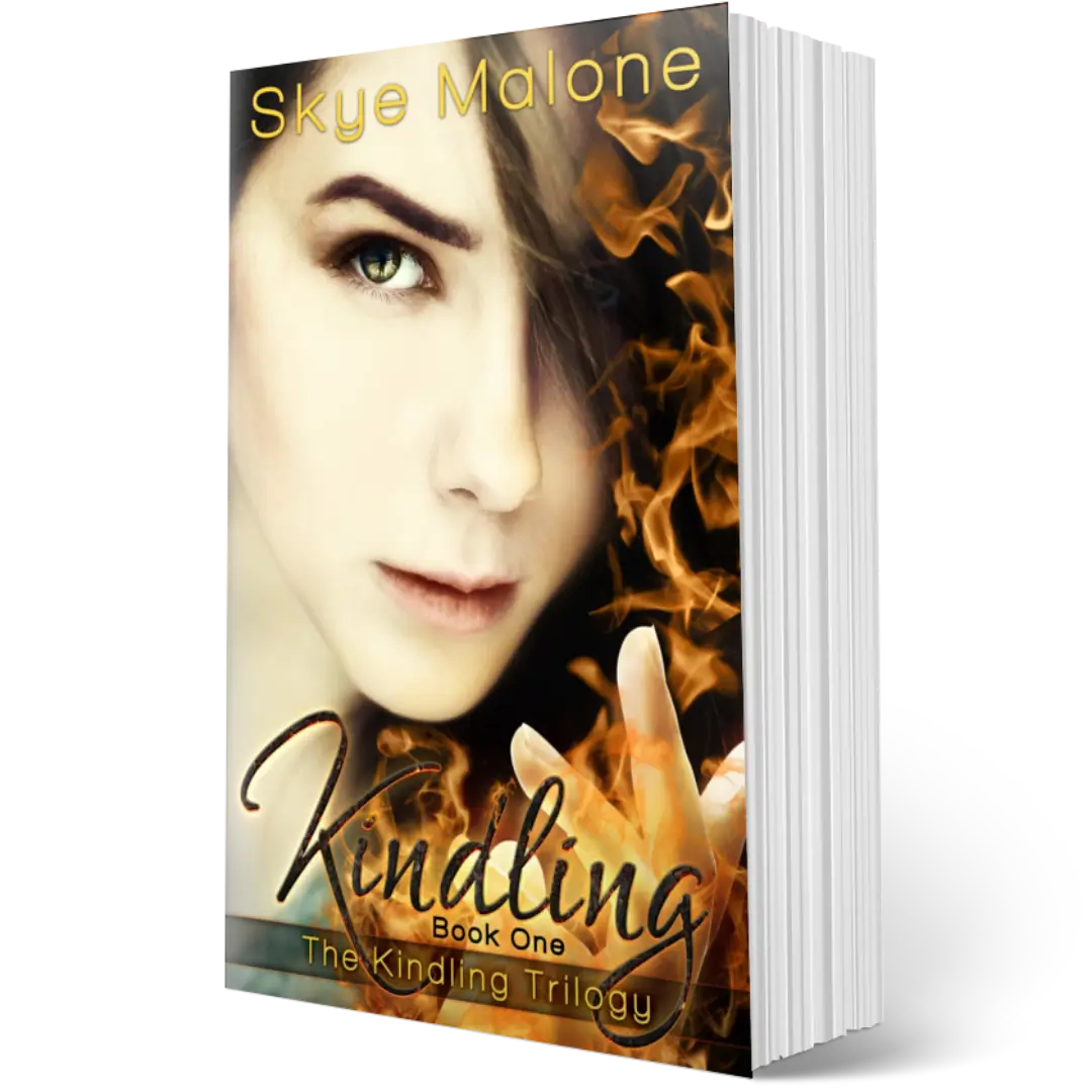 The paperback edition of Kindling by Skye Malone, book one of the Kindling trilogy. A girl with a serious expression and dark hair holds up one hand with fire coming from her fingers. 